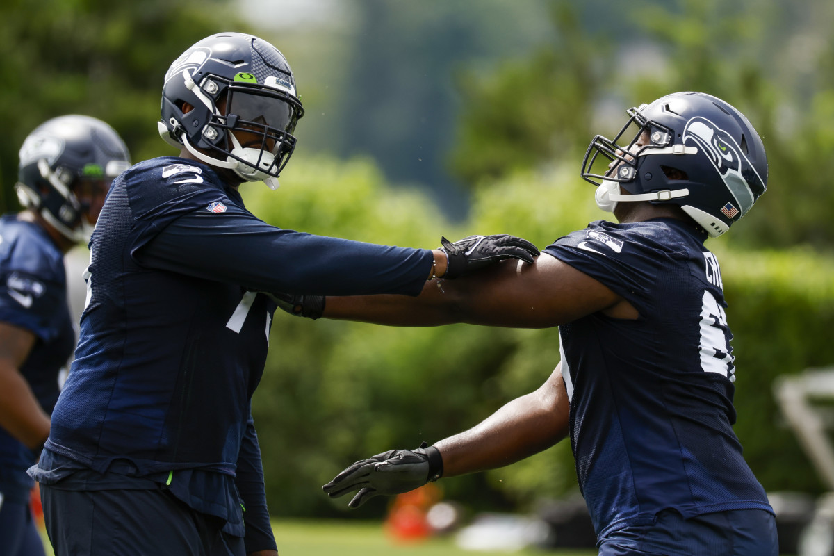 Seattle Seahawks tackle Greg Eiland (75, left) and offensive tackle Charles Cross (67, right) participate in a drill during minicamp practice at the Virginia Mason Athletic Center Field.